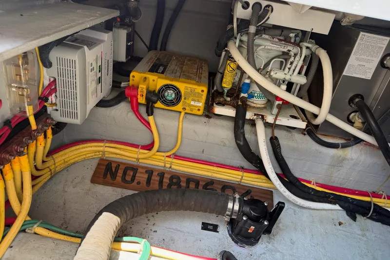 Slide: The Image of Engine compartment of a 2006 Back Cove 29 boat, showcasing wiring and mechanical components. - 41