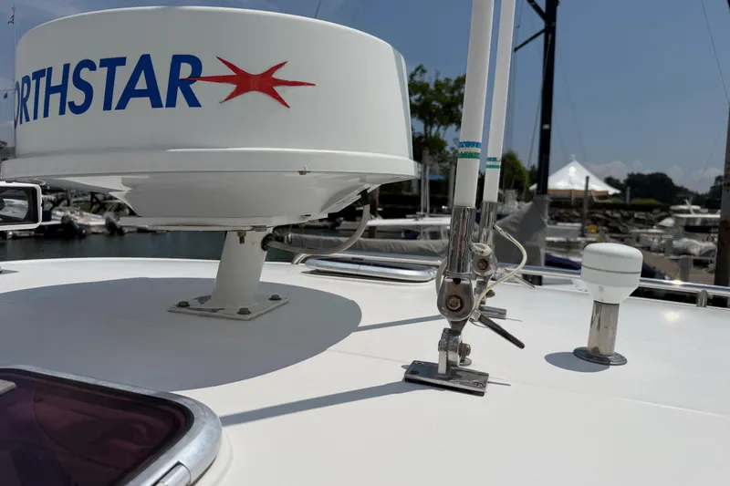 Slide: The Image of Radar and antennas on a 2006 Back Cove 29 boat, docked at a marina. - 36