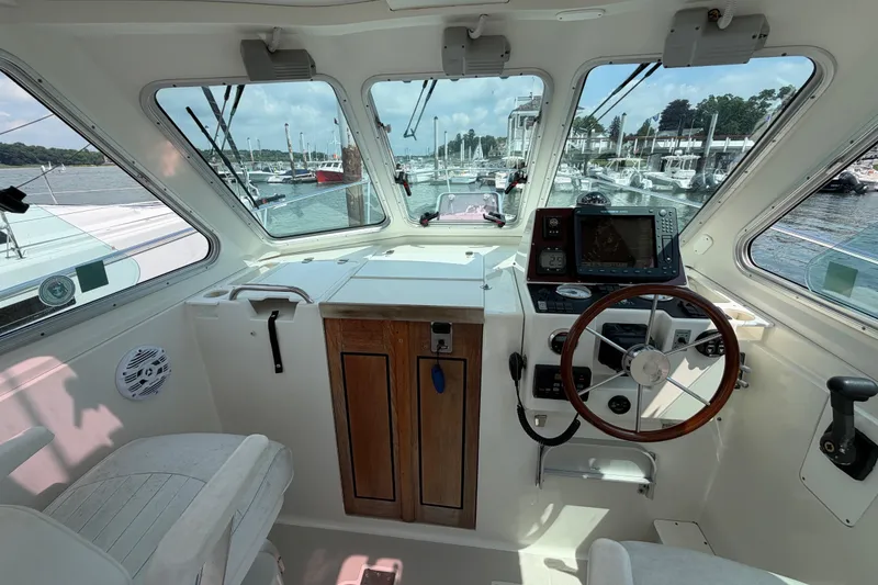 Slide: The Image of Interior view of a 2006 Back Cove 29 boat cockpit with steering wheel and navigation equipment. - 20