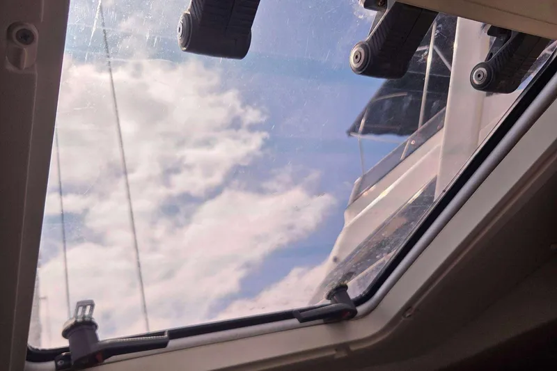 Slide: The Image of View through a J Boats J/130 hatch, showcasing a clear sky and clouds. - 42