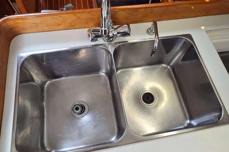 Slide: The Image of Stainless steel double sink on 1994 J Boats J/130 yacht with wooden trim. - 44