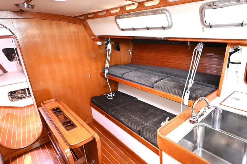 Slide: The Image of Interior of 1994 J Boats J/130 sailboat with wooden finish and compact seating area. - 30