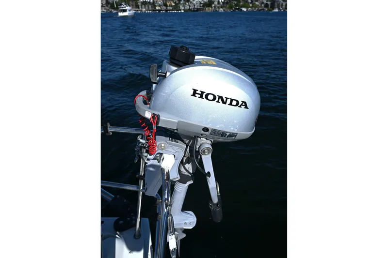 Slide: The Image of Honda outboard motor on a 1994 J Boats J/130, with scenic water backdrop. - 25