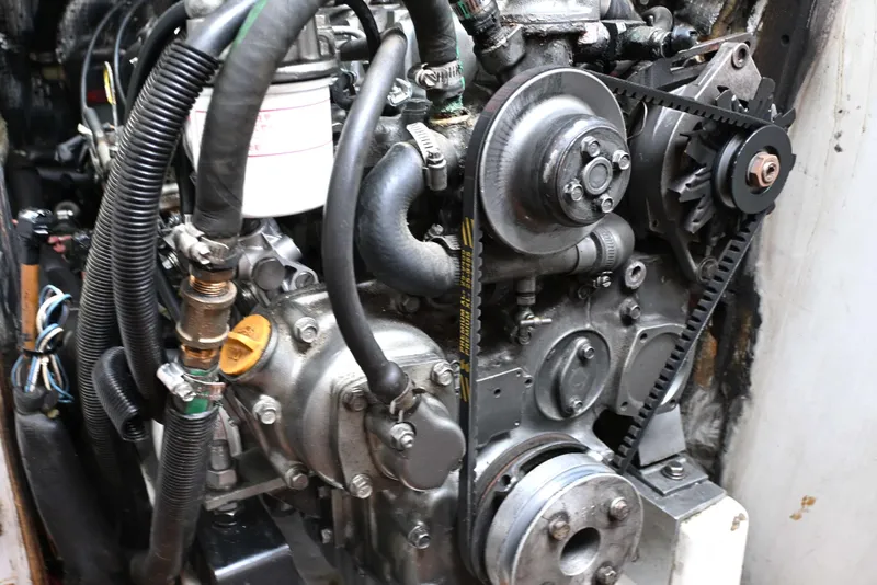 Slide: The Image of Engine of a 1994 J Boats J/130 sailboat, showcasing mechanical components and belts. - 51
