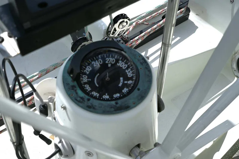 Slide: The Image of Compass on 1994 J Boats J/130 sailboat, surrounded by nautical ropes and equipment. - 21