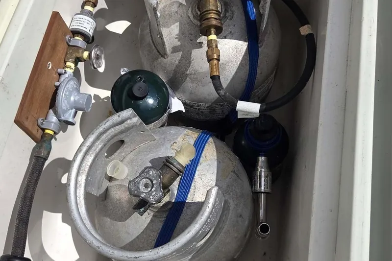 Slide: The Image of Propane tanks and fittings in a 1994 J Boats J/130 sailboat compartment. - 17