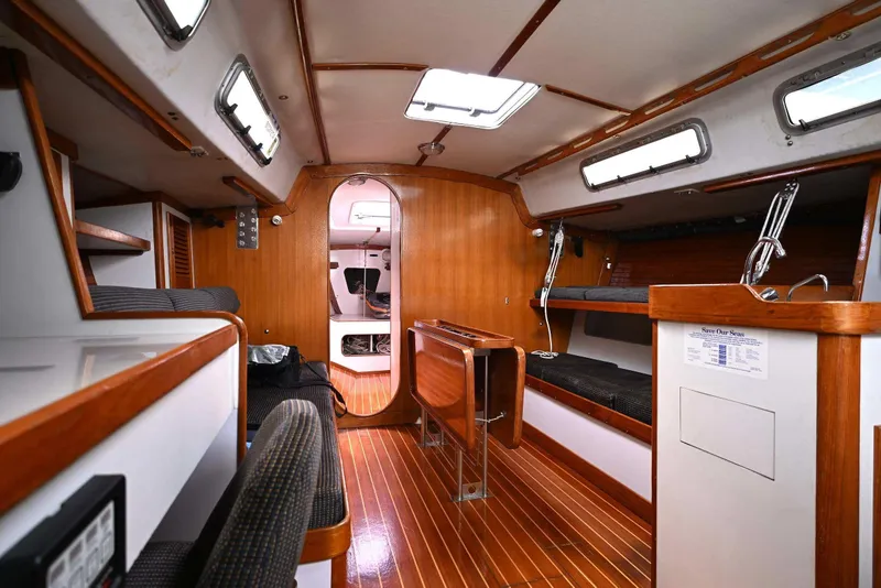 Slide: The Image of Interior of 1994 J Boats J/130 sailboat with wood accents and seating area. - 28