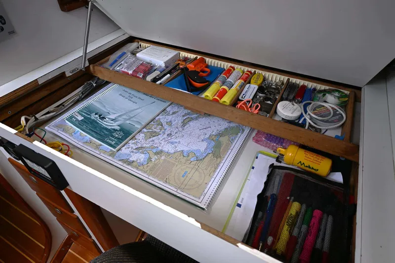 Slide: The Image of Navigational tools and maps in a 1994 J Boats J/130 sailboat drawer. - 50