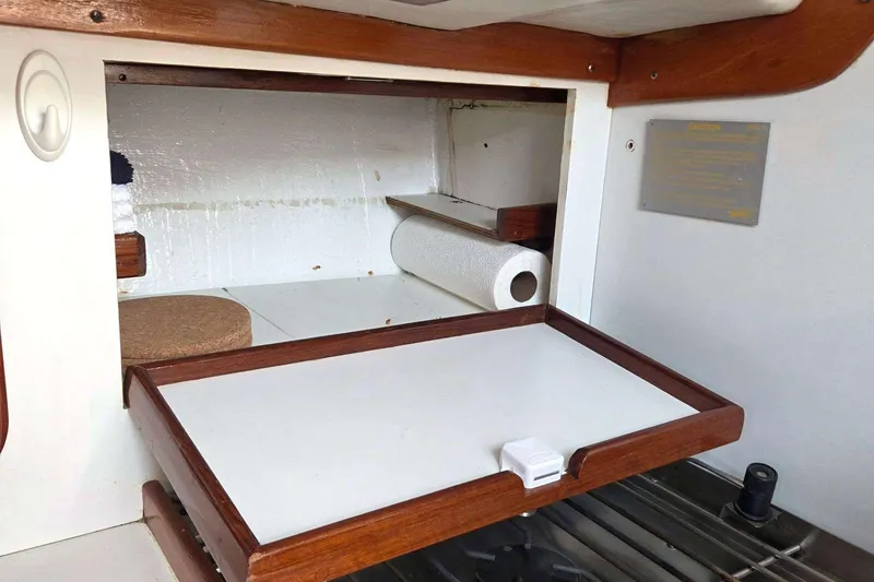 Slide: The Image of Interior of 1994 J Boats J/130, featuring a wooden shelf with paper towel holder. - 46