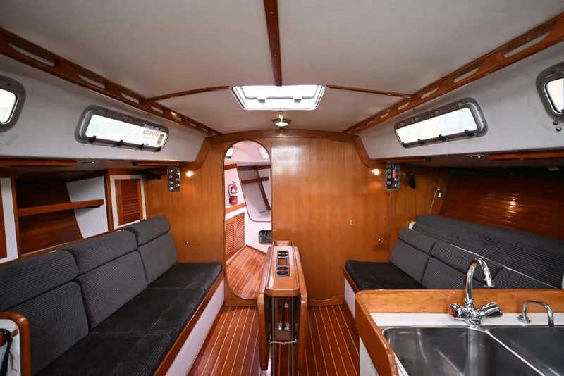 Slide: The Image of Interior of 1994 J Boats J/130 sailboat with wood finish and cozy seating. - 29