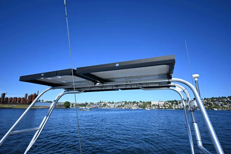 Slide: The Image of Solar panels on a 1994 J Boats J/130 yacht, with a scenic waterfront view. - 26