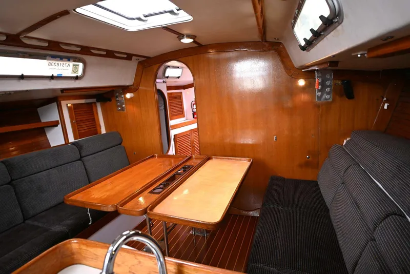 Slide: The Image of Interior of 1994 J Boats J/130 sailboat with wooden finishes and cozy seating area. - 31