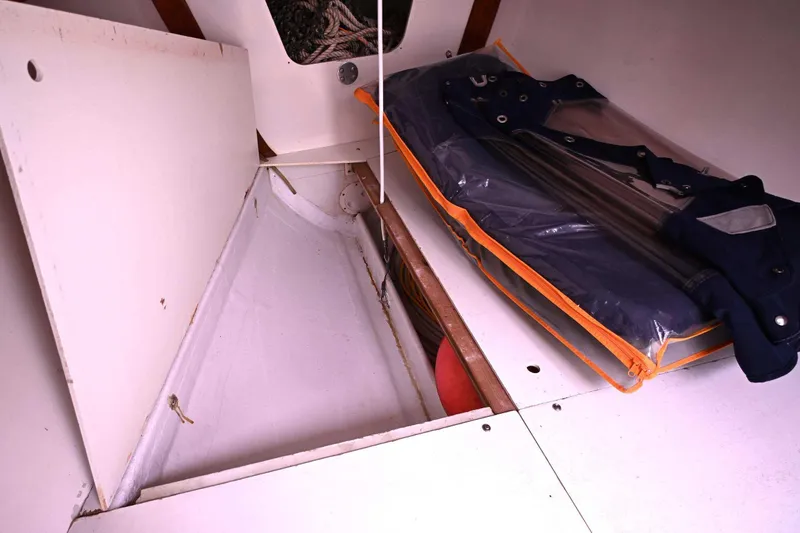 Slide: The Image of Storage compartment on a 1994 J Boats J/130 sailboat, featuring organized equipment. - 41