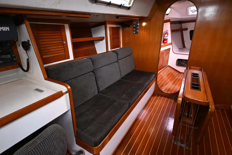 Slide: The Image of Interior of 1994 J Boats J/130 sailboat with wooden finishes and seating area. - 27