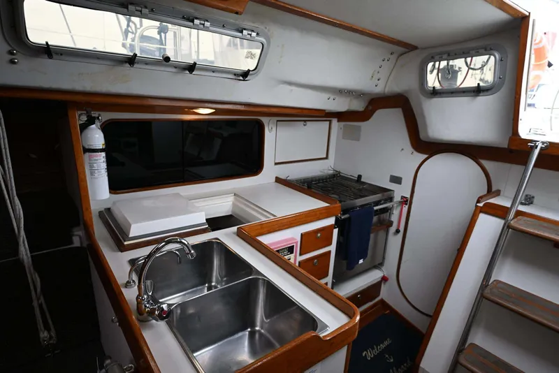 Slide: The Image of Interior of 1994 J Boats J/130 sailboat featuring kitchen sink and stove area. - 33