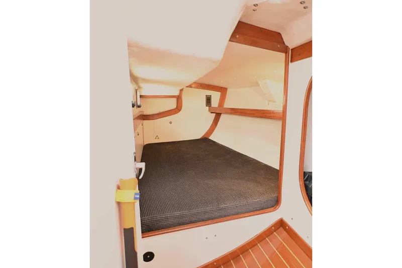 Slide: The Image of Interior cabin of 1994 J Boats J/130 sailboat with wooden trim and cozy sleeping area. - 36