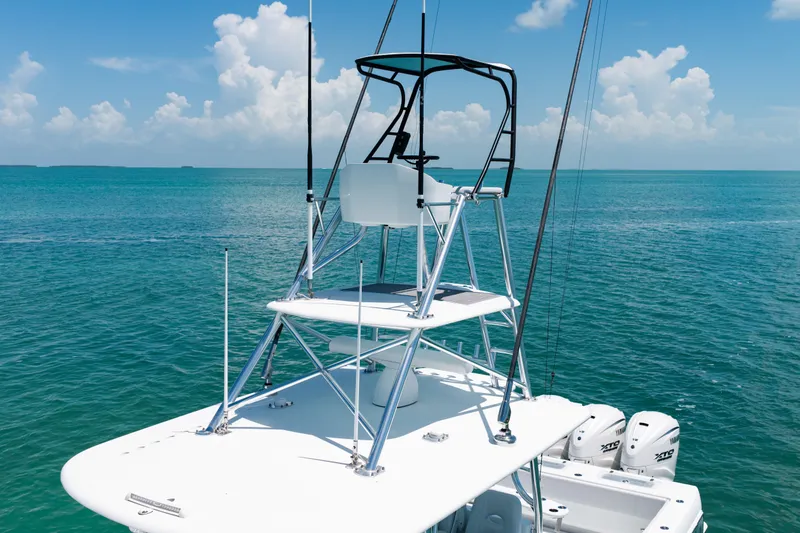 Slide: The Image of A 2023 Contender 44 ST with an elevated helm station on open water. - 24