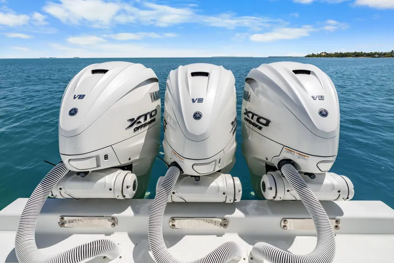 Slide: The Image of Three Yamaha XTO V8 outboard engines are mounted on the stern of a boat in open water. - 34