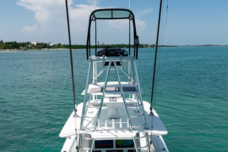 Slide: The Image of A 2023 Contender 44 ST with an elevated helm station on calm, blue waters. - 23