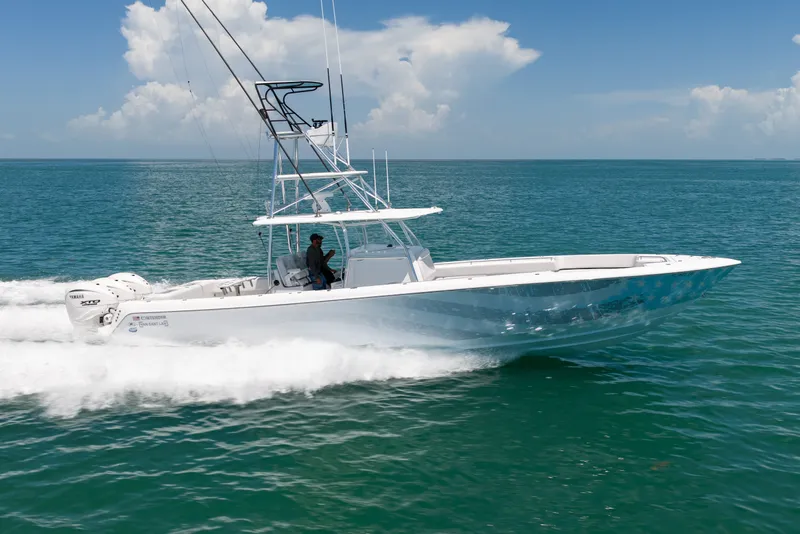 Slide: The Image of A 2023 Contender 44 ST speeds across open water. It features a sleek, modern design. - 41