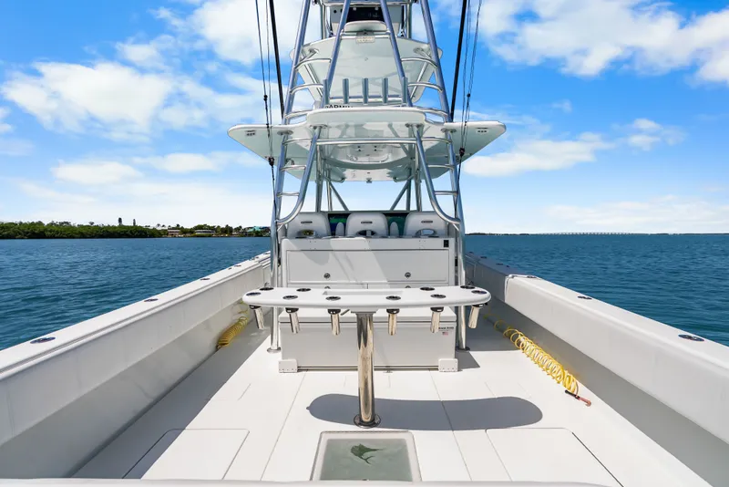 Slide: The Image of The image shows a 2023 Contender 44 ST boat on the water with a clear sky. - 31