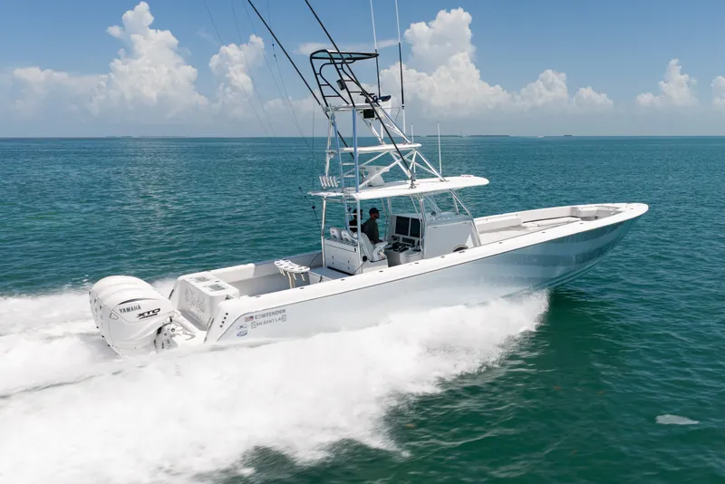 Slide: The Image of A 2023 Contender 44 ST speeds across the blue sea under a clear sky. - 42