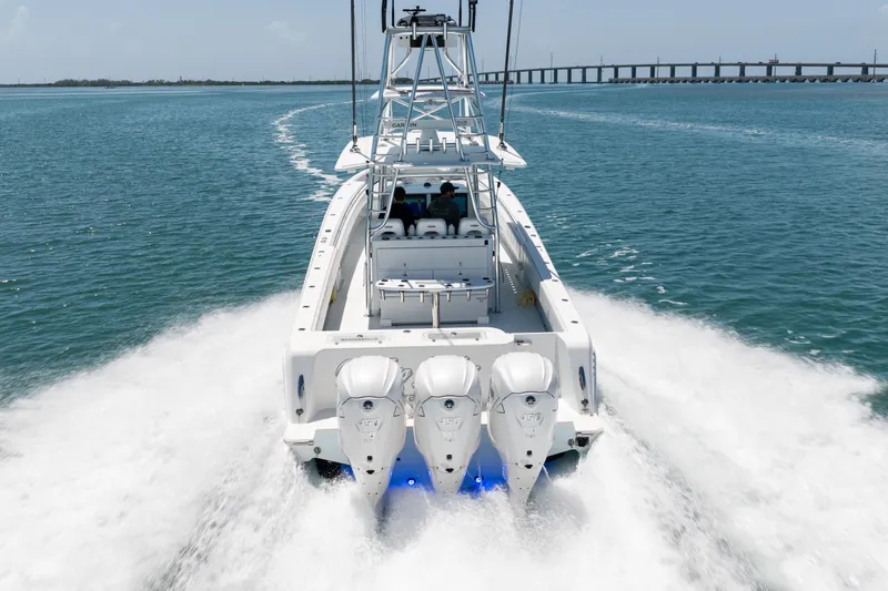 Slide: The Image of A 2023 Contender 44 ST speeding on the water, featuring three outboard engines. - 43