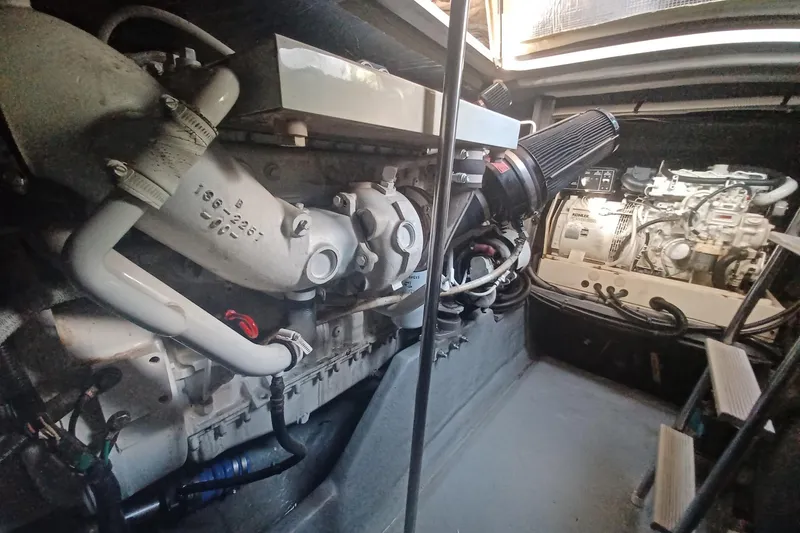 Slide: The Image of Engine room of a 1996 Sea Ray 450 Sundancer yacht, showcasing mechanical components. - 27