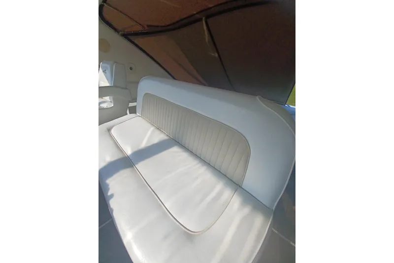 Slide: The Image of 1996 Sea Ray 450 Sundancer interior seating with white upholstery and sleek design. - 12