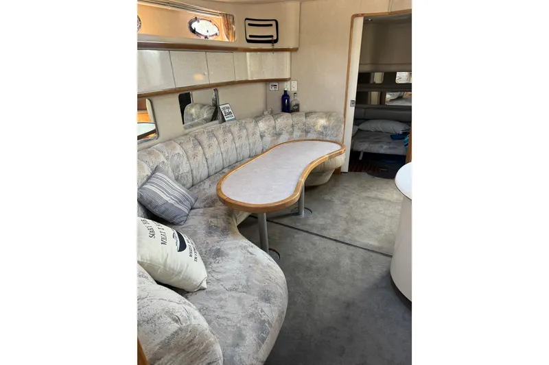 Slide: The Image of Interior of 1996 Sea Ray 450 Sundancer yacht with plush seating and elegant decor. - 22