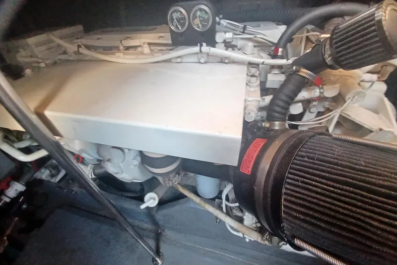 Slide: The Image of Engine compartment of a 1996 Sea Ray 450 Sundancer boat, showcasing mechanical components. - 29