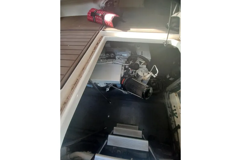 Slide: The Image of Engine compartment of a 1996 Sea Ray 450 Sundancer boat, showcasing mechanical components. - 26