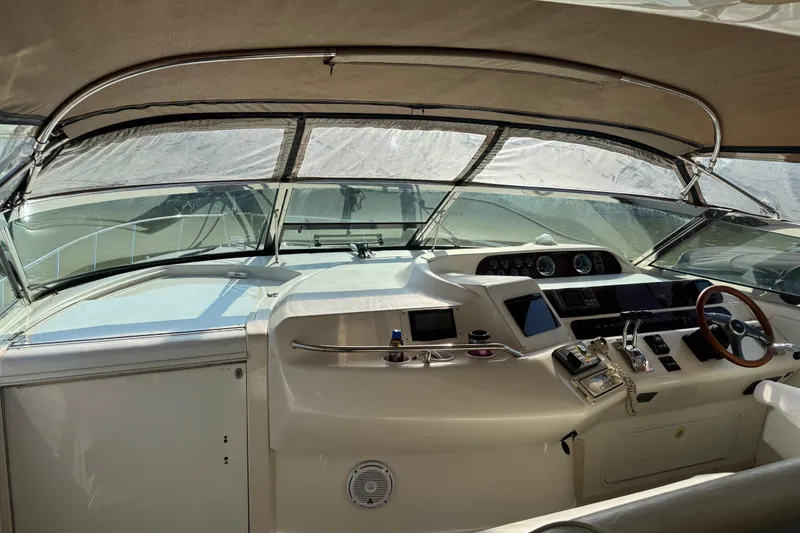 Slide: The Image of 1996 Sea Ray 450 Sundancer helm with modern controls and panoramic windshield. - 8