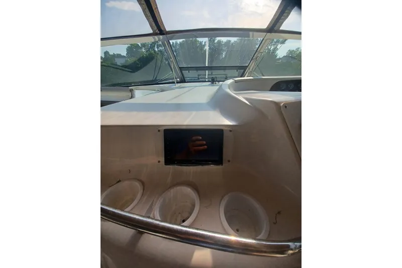Slide: The Image of 1996 Sea Ray 450 Sundancer dashboard with windshield view and cup holders. - 11