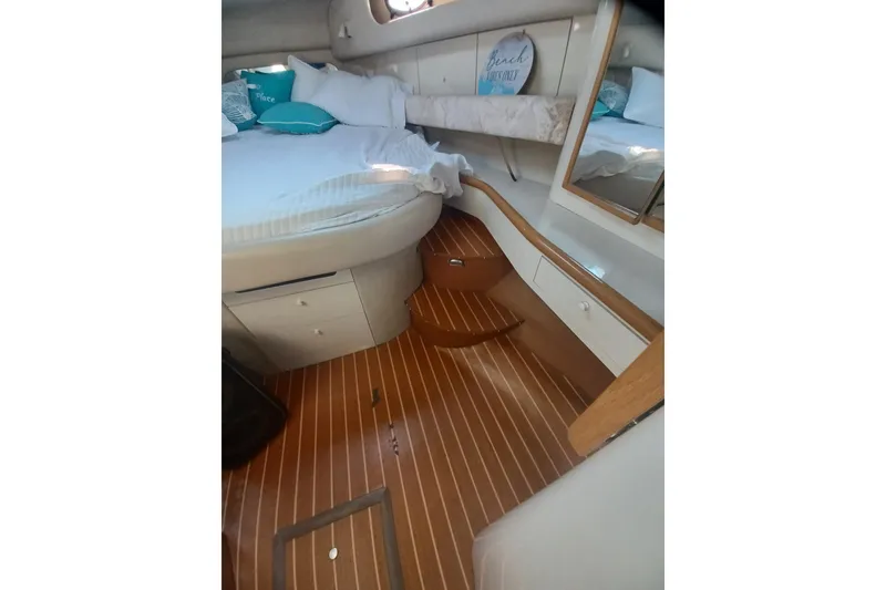 Slide: The Image of Luxurious interior of 1996 Sea Ray 450 Sundancer yacht with wooden flooring and cozy bedding. - 19