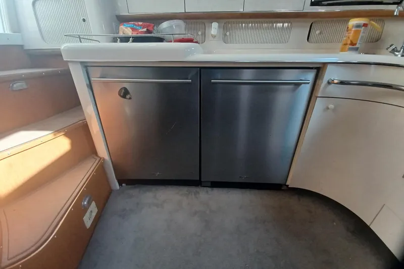 Slide: The Image of Interior kitchen of 1996 Sea Ray 450 Sundancer yacht with stainless steel appliances. - 16