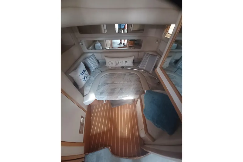 Slide: The Image of Interior of 1996 Sea Ray 450 Sundancer with cozy seating and decorative pillows. - 25