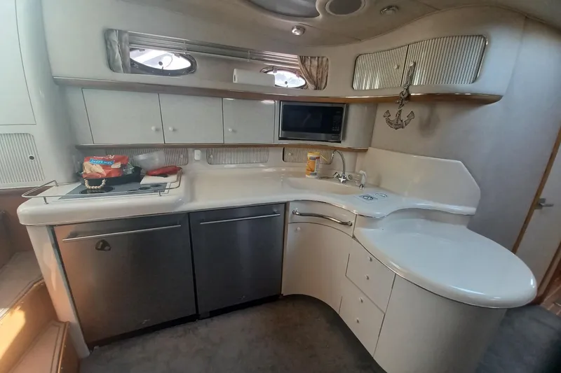 Slide: The Image of Interior view of 1996 Sea Ray 450 Sundancer yacht kitchen with modern amenities. - 15