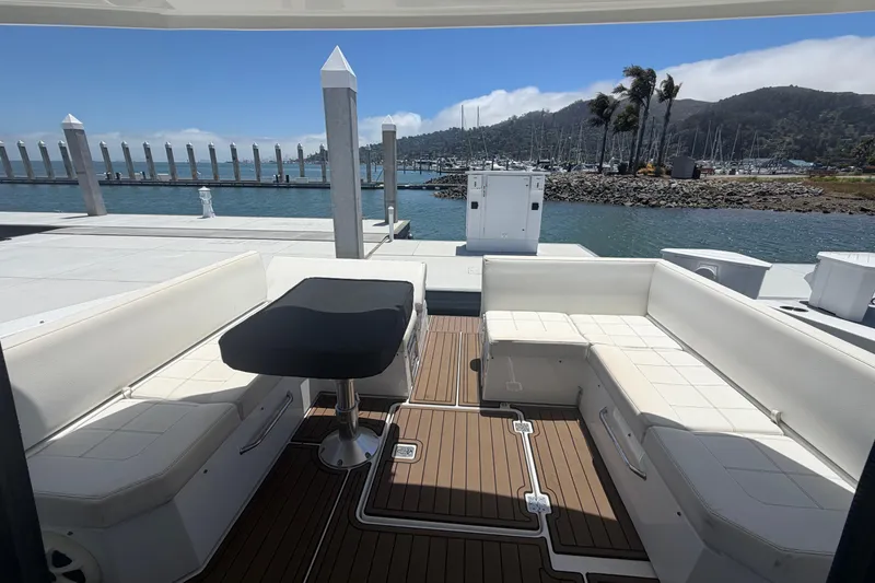 Slide: The Image of Luxury 2015 Cruisers 390 yacht deck with white seating and scenic marina view. - 3