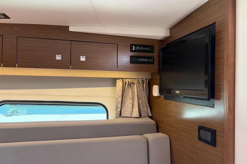 Slide: The Image of Interior of 2015 Cruisers 390 yacht with TV, stereo, and wooden cabinetry. - 15