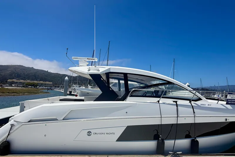 The Image of 2015 Cruisers 390 yacht docked at marina under clear blue sky. - 1