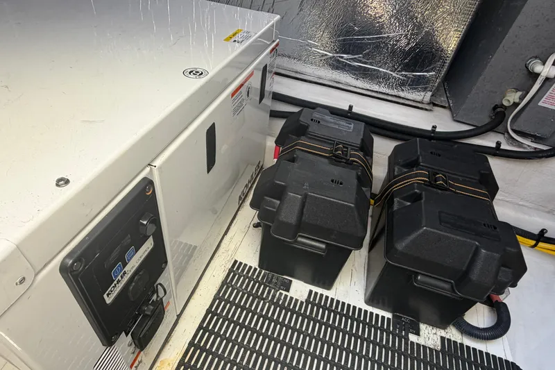 Slide: The Image of Engine room of 2015 Cruisers 390 with generator and battery boxes. - 16
