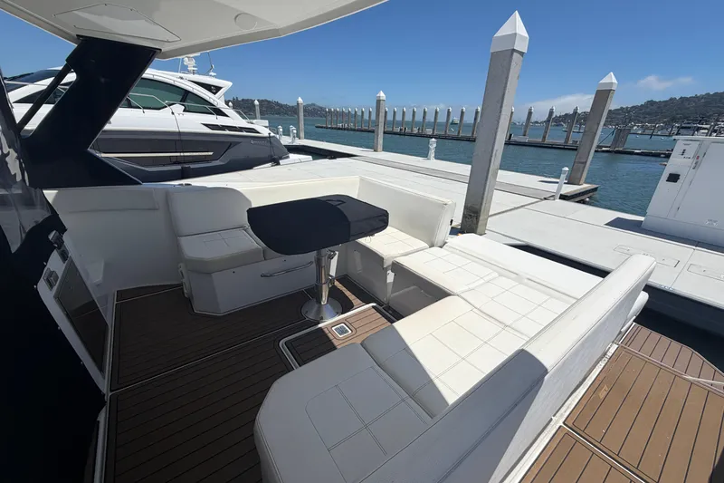 Slide: The Image of Luxury 2015 Cruisers 390 yacht interior with elegant seating at marina dock. - 4
