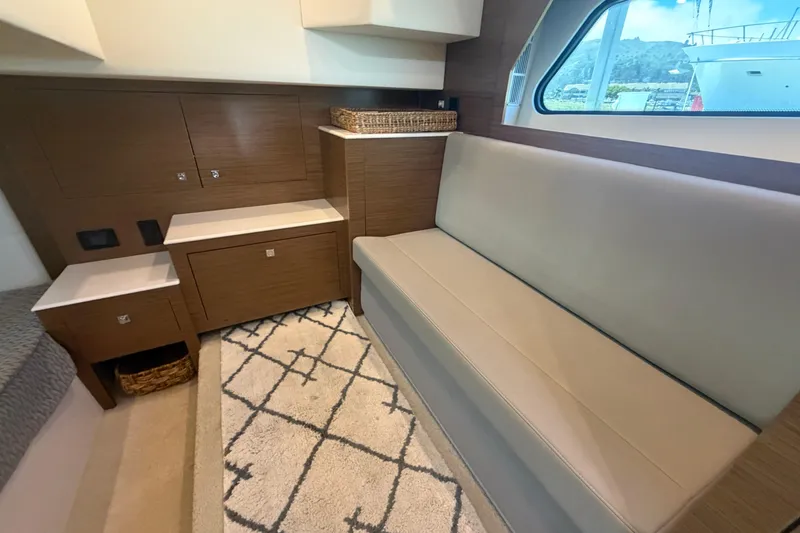 Slide: The Image of Interior of 2015 Cruisers 390 yacht with modern seating and storage cabinets. - 12