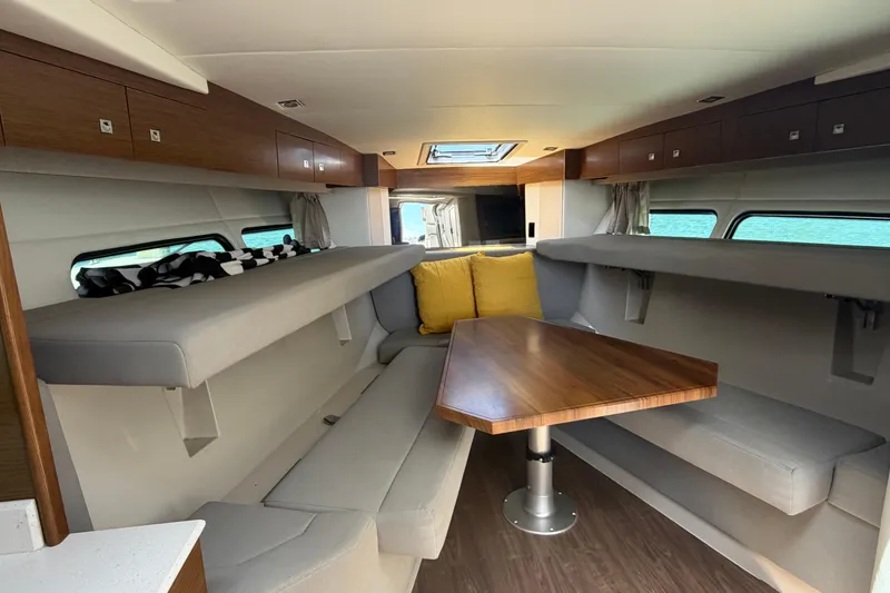 Slide: The Image of Interior of 2015 Cruisers 390 yacht with modern seating and wooden table. - 9