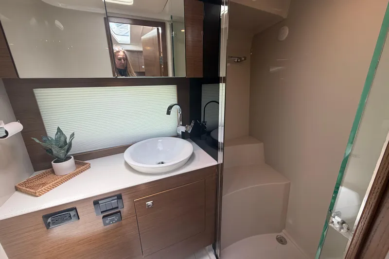Slide: The Image of Modern bathroom in a 2015 Cruisers 390 yacht with sink, shower, and mirror. - 11