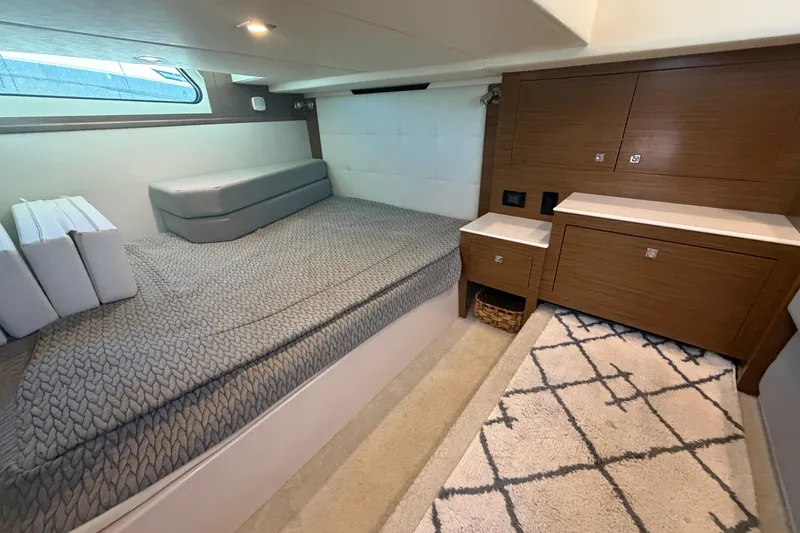 Slide: The Image of Luxurious 2015 Cruisers 390 yacht cabin with modern wood cabinetry and cozy bedding. - 13