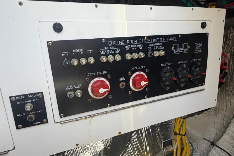 Slide: The Image of Engine room distribution panel of 2015 Cruisers 390 boat with various controls and switches. - 17