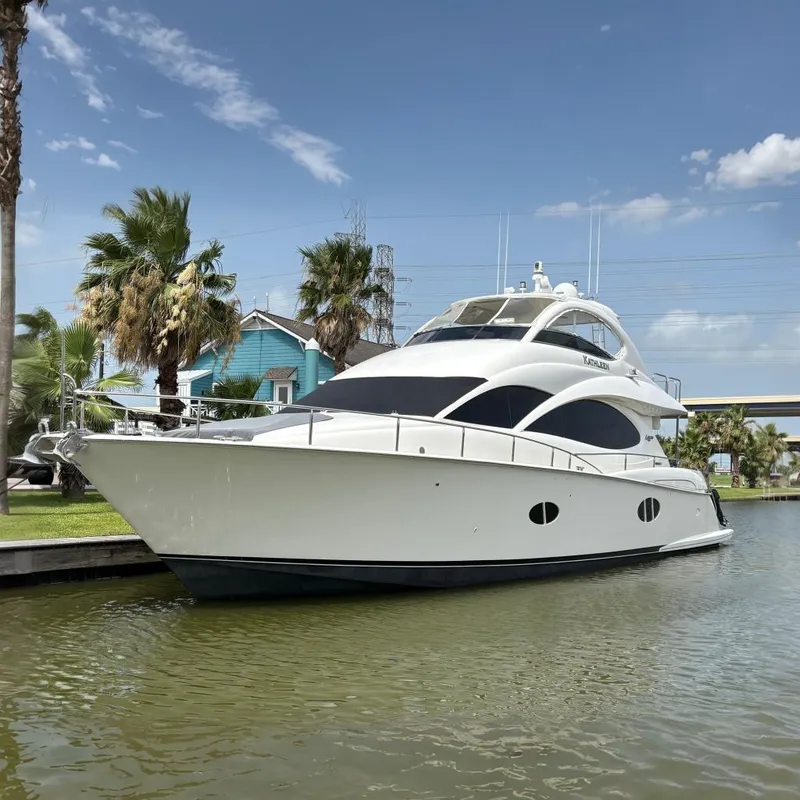 The Image of 2007 Lazzara 74 Motoryacht docked by palm trees under a clear blue sky. - 0