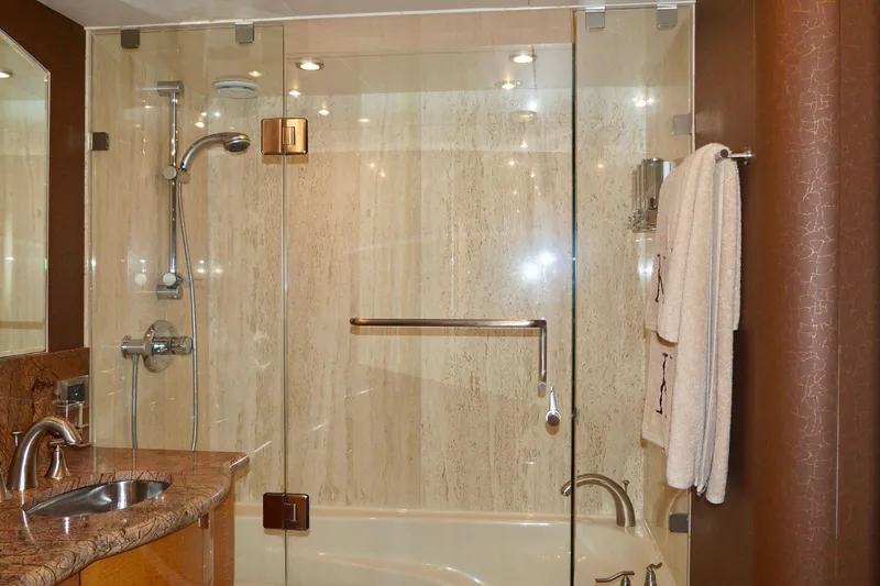 Slide: The Image of Luxurious bathroom in a 2007 Lazzara 74 Motoryacht with glass shower and marble accents. - 50